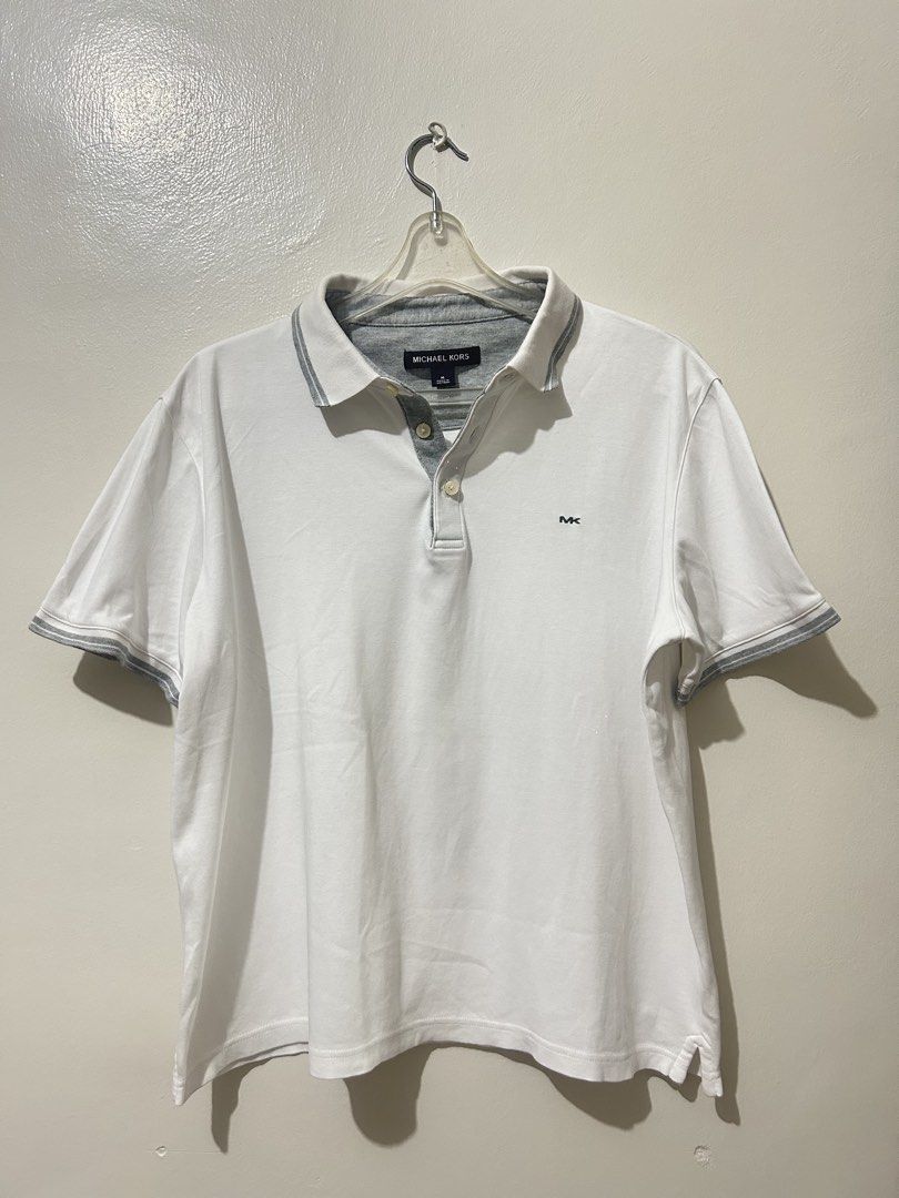 Michael Kors White Polo Shirt (Category: Tshirts & Polo Shirts ) located in Manila. Submitted by timo_clutters18 (Listing ID 1468573579, Image 1). Description: Michael Kors White Polo Shirt Size: M (24x23) Condition: 9/10 *stain on collar MOP: G-Cash/COD Location: Quezon City.