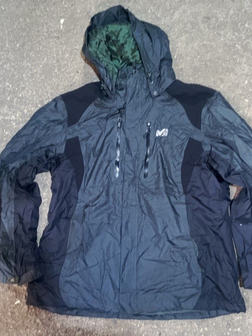 Millet Mountain By Experience Waterproof Outdoor Jacket (Category: Coats, Jackets and Outerwear) located in City of Isabela. Submitted by warmbird.d06e6f (Listing ID 1468548919, Image 1). Description: - Brand: Millet Mountain - Color: Dark grey and black with green inner hood lining - Features: Hood with adjustable drawstrings and secure zip chest pockets - Material: Weather-resistant shell fabric - Best For: Hiking, camping, and rainy weather.