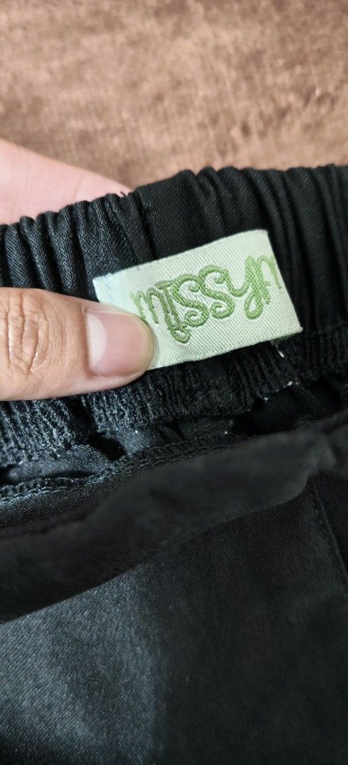 Missy M Black Straight Leg Pants (Category: Jeans) located in Manila. Submitted by snz_shop (Listing ID 1468533408, Image 2). Description: - Brand: Missy M - Style: Black straight leg pants - Waist: Super comfy elastic waistband for easy pull-on - Fabric: Nice textured material with a subtle sheen - Fit: Clean lines and relaxed fit through the legs - Versatility: Great for daily casual wear or dressing up slightly.