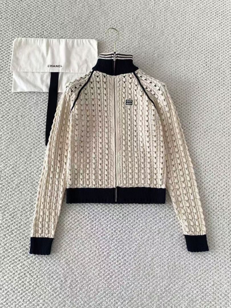Miu Miu Knit Zip Up Cardigan (Category: Coats, Jackets and Outerwear) located in Malabon City. Submitted by ojaswibent53454 (Listing ID 1468556883, Image 2). Description: - Brand new cream crochet knit cardigan - Contrast navy blue ribbed collar, cuffs, and hem - Full front zipper closure - Signature Miu Miu logo patch on the chest - Long raglan sleeves with seam piping - Includes original hang tag and dust bag.