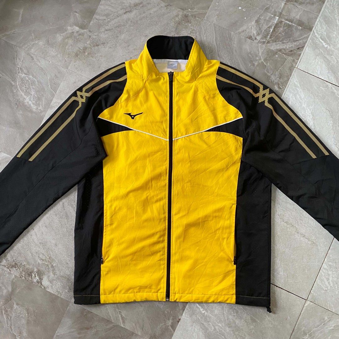Mizuno Black and Yellow Athletic Track Jacket (Category: Coats, Jackets and Outerwear) located in Butuan. Submitted by jc13thrifts (Listing ID 1468709358, Image 2). Description: - Brand: Mizuno - Colorway: Striking yellow and black - Design: Full zip front, mock neck collar, and patterned striping along sleeves and shoulders - Branding: Embroidered Mizuno Runbird logo on the right chest - Comfort: Breathable fabric panels under the arms and down 