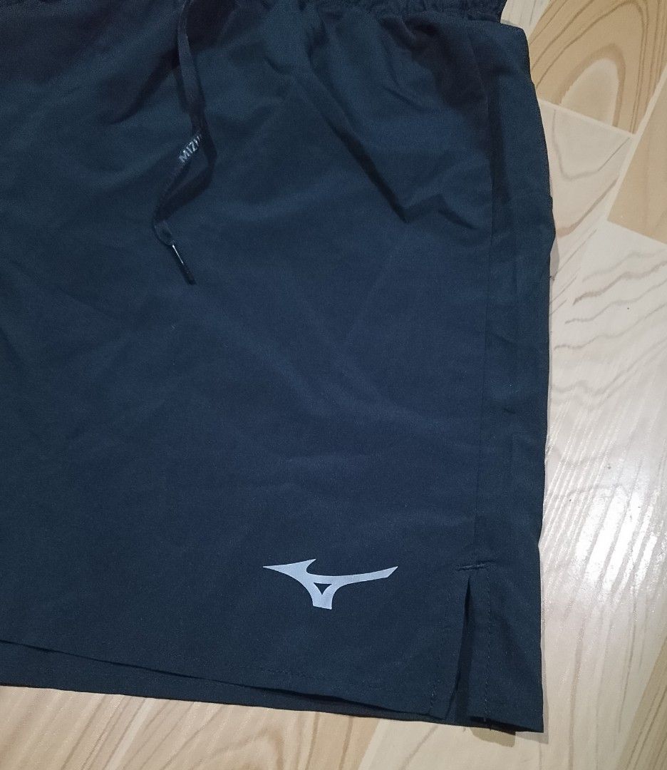 Mizuno Men's Medium Running Shorts Dark Grey (Category: Shorts) located in San Jose del Monte. Submitted by azetor (Listing ID 1468592013, Image 3). Description: Mizuno men's running shorts in dark grey. Size medium. Elastic waistband with adjustable drawstring featuring logo print. Lightweight fabric with side slits for easy movement. Includes a zippered pocket on the back. Made in Thailand. - size medium on tags - measurements - waistline 28 st