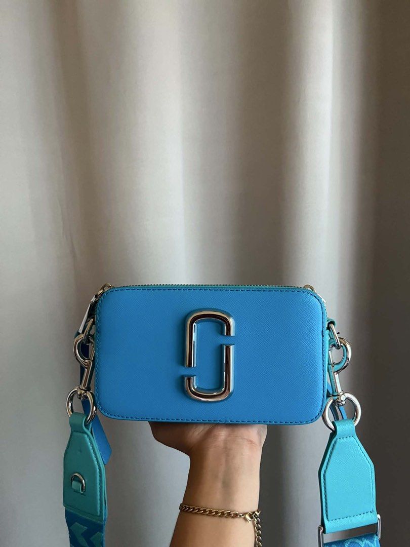 MJ Snapshot Camera Bag Turquoise Blue (Category: Luxury Bags & Wallets) located in Pagadian. Submitted by chiccsilog (Listing ID 1468517472, Image 3). Description: - Brand: Marc Jacobs Snapshot Bag - Color: Vibrant turquoise blue with silver hardware - Condition: Very clean inside and out - Features: Double zip compartments and structured leather body - Inclusions: Wide patterned fabric strap and matching dust bag - Size: Great everyday size for 