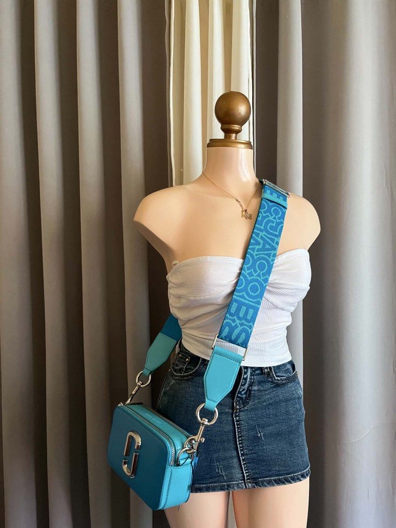 MJ Snapshot Camera Bag Turquoise Blue (Category: Luxury Bags & Wallets) located in Pagadian. Submitted by chiccsilog (Listing ID 1468517472, Image 2). Description: - Brand: Marc Jacobs Snapshot Bag - Color: Vibrant turquoise blue with silver hardware - Condition: Very clean inside and out - Features: Double zip compartments and structured leather body - Inclusions: Wide patterned fabric strap and matching dust bag - Size: Great everyday size for 