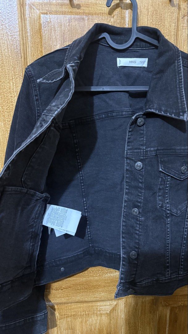 MNG Black Denim Jacket (Category: Coats, Jackets and Outerwear) located in Makati City. Submitted by ario_drobe (Listing ID 1468683694, Image 3). Description: - Brand: MNG - Style: Classic button-up denim jacket with washed black finish - Size: XXL - Pockets: Functional chest pockets and side welt pockets - Origin: Made in Bangladesh - Condition/Details: Versatile everyday staple that goes with any outfit.