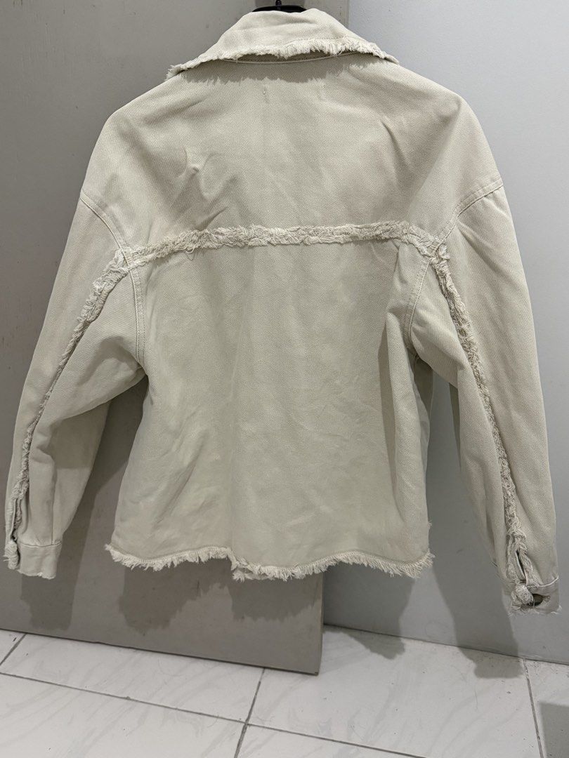 MNG Mango Denim Jacket Raw Hem Cream Beige XS (Category: Coats, Jackets and Outerwear) located in Mandaluyong City. Submitted by trovebya (Listing ID 1468595321, Image 2). Description: - Brand: Mango - Item: Cream denim jacket - Size: XS - Origin: Made in Bangladesh - Design: Button-up front, two chest pockets, and raw frayed edge details on the collar, pockets, hem, and back seam - Style: Great casual layering piece.