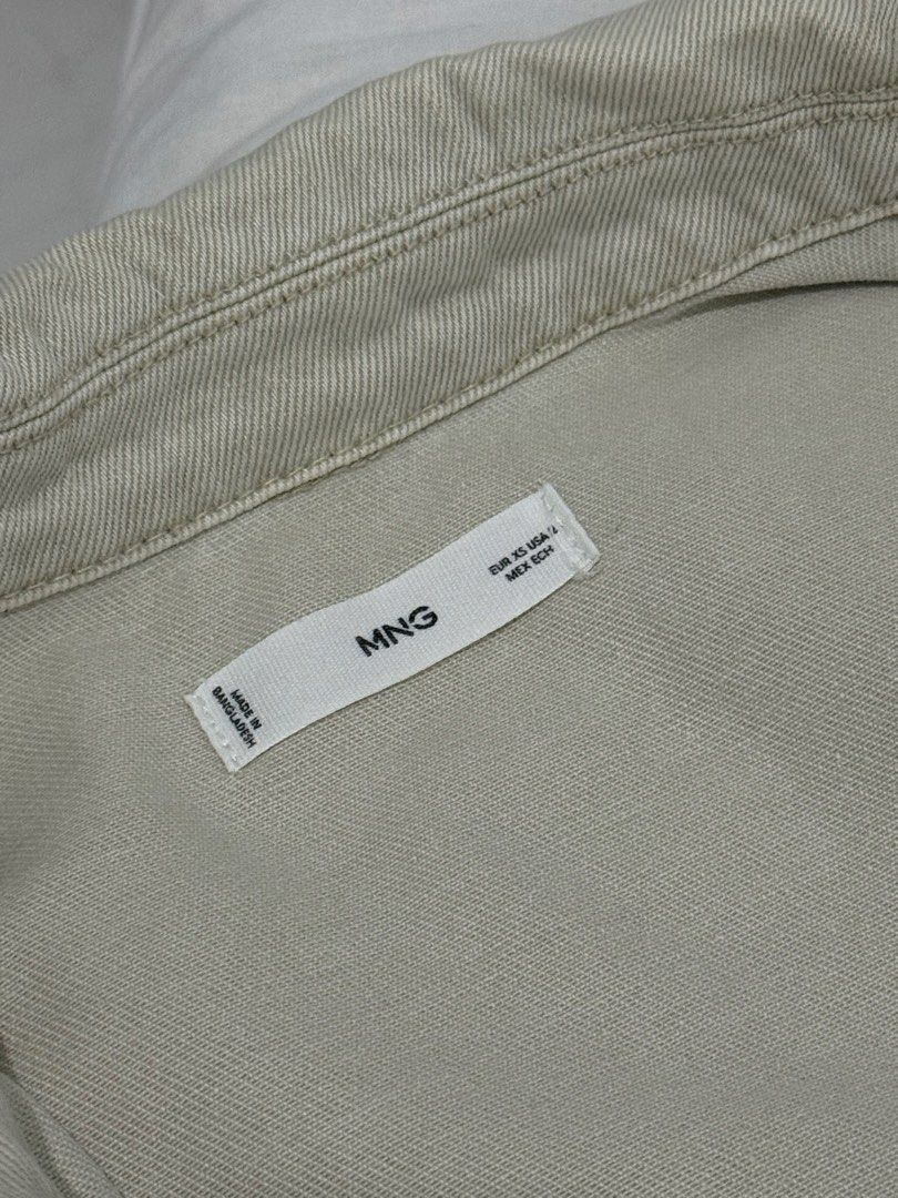 MNG Mango Denim Jacket Raw Hem Cream Beige XS (Category: Coats, Jackets and Outerwear) located in Mandaluyong City. Submitted by trovebya (Listing ID 1468595321, Image 3). Description: - Brand: Mango - Item: Cream denim jacket - Size: XS - Origin: Made in Bangladesh - Design: Button-up front, two chest pockets, and raw frayed edge details on the collar, pockets, hem, and back seam - Style: Great casual layering piece.