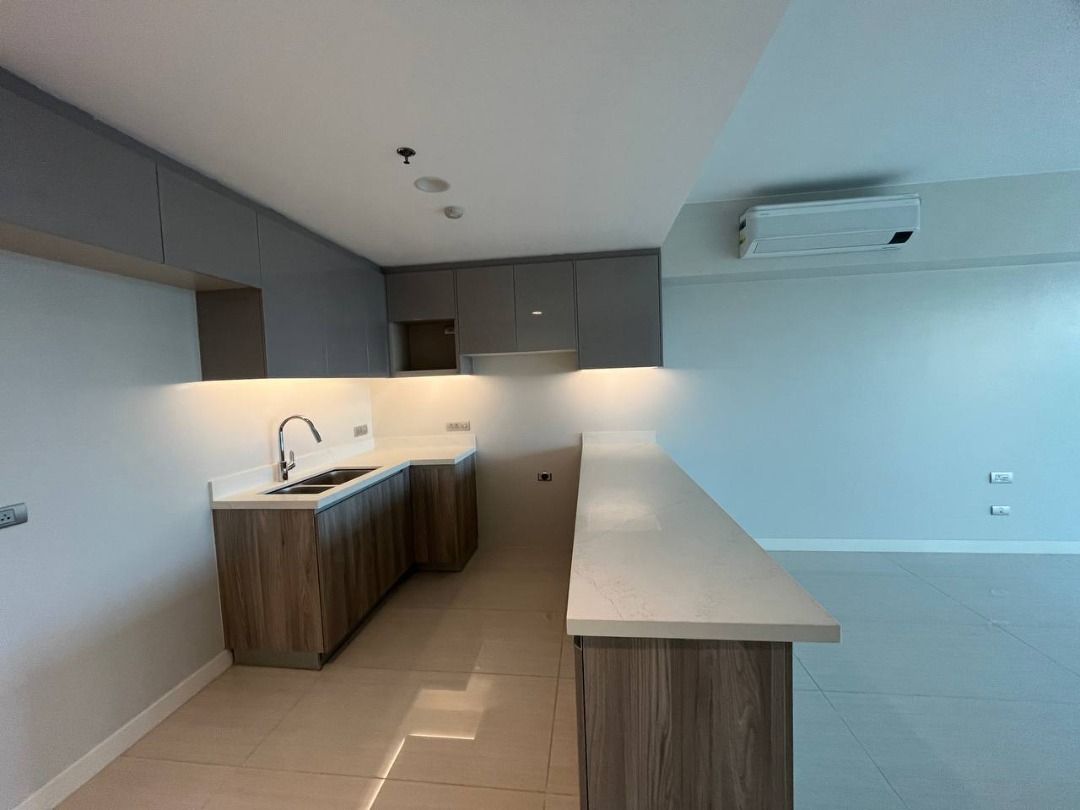 Modern Kitchen Counter Island with Upper and Lower Cabinets (Category: Apartments & Condos) located in Caloocan City. Submitted by cosmicbear_acc7ba (Listing ID 1468551544, Image 3). Description: - Modern kitchen setup, perfect for new condo units - Includes upper and lower wooden cabinets in a clean grey and wood-grain finish - Durable white quartz countertops with stainless steel sink and sleek faucet - Integrated warm under-cabinet lighting fo