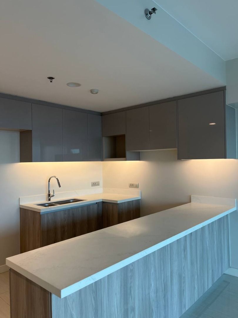 Modern Kitchen Counter Island with Upper and Lower Cabinets (Category: Apartments & Condos) located in Caloocan City. Submitted by cosmicbear_acc7ba (Listing ID 1468551544, Image 2). Description: - Modern kitchen setup, perfect for new condo units - Includes upper and lower wooden cabinets in a clean grey and wood-grain finish - Durable white quartz countertops with stainless steel sink and sleek faucet - Integrated warm under-cabinet lighting fo