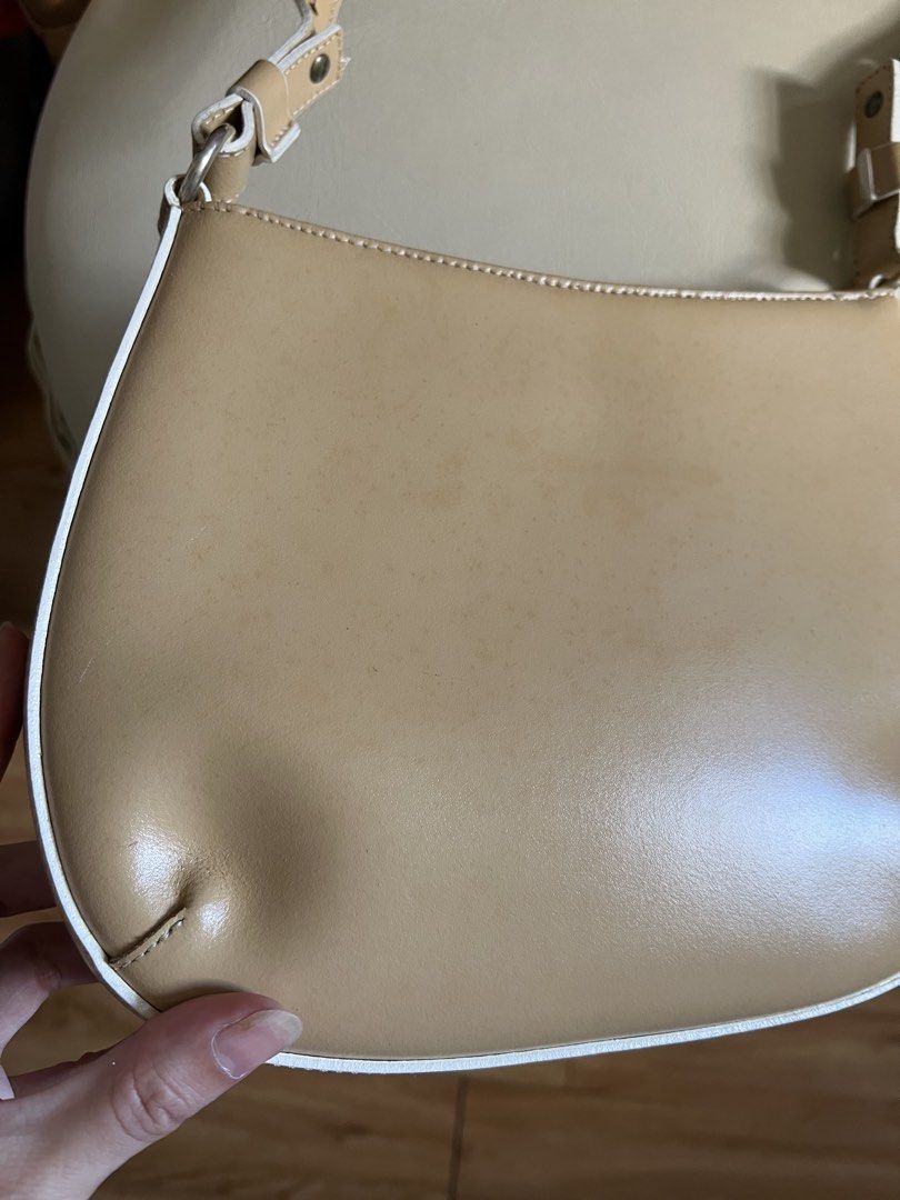 MONTINI beige leather shoulder bag (Category: Shoulder Bags) located in Rizal. Submitted by s0apandglory (Listing ID 1468555000, Image 2). Description: - Brand: MONTINI I bought in UK amazon (imported) - Material: Beige genuine leather with white contrast piping - Features: Compact structured shape, adjustable strap with metallic hardware, secure top zipper closure with branded gold-tone pull, and debossed front logo - Condition: Minor surface we