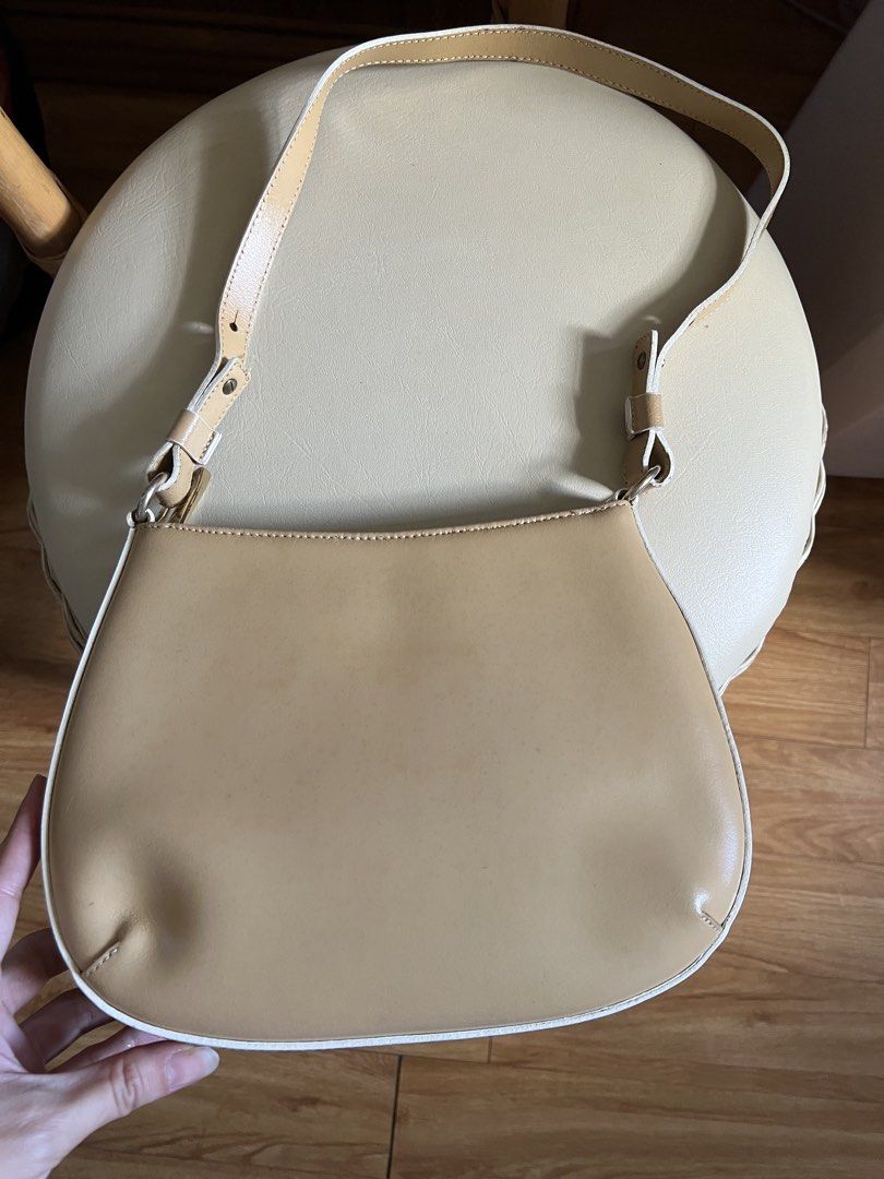 MONTINI beige leather shoulder bag (Category: Shoulder Bags) located in Rizal. Submitted by s0apandglory (Listing ID 1468555000, Image 1). Description: - Brand: MONTINI I bought in UK amazon (imported) - Material: Beige genuine leather with white contrast piping - Features: Compact structured shape, adjustable strap with metallic hardware, secure top zipper closure with branded gold-tone pull, and debossed front logo - Condition: Minor surface we