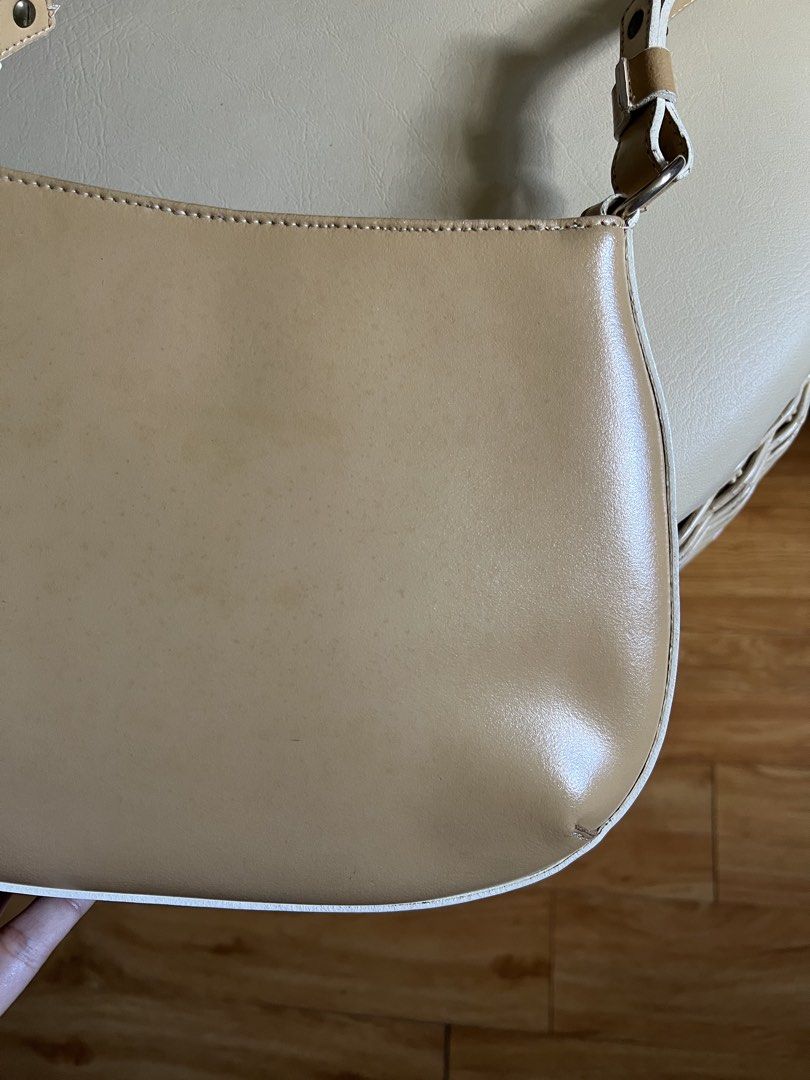MONTINI beige leather shoulder bag (Category: Shoulder Bags) located in Rizal. Submitted by s0apandglory (Listing ID 1468555000, Image 3). Description: - Brand: MONTINI I bought in UK amazon (imported) - Material: Beige genuine leather with white contrast piping - Features: Compact structured shape, adjustable strap with metallic hardware, secure top zipper closure with branded gold-tone pull, and debossed front logo - Condition: Minor surface we