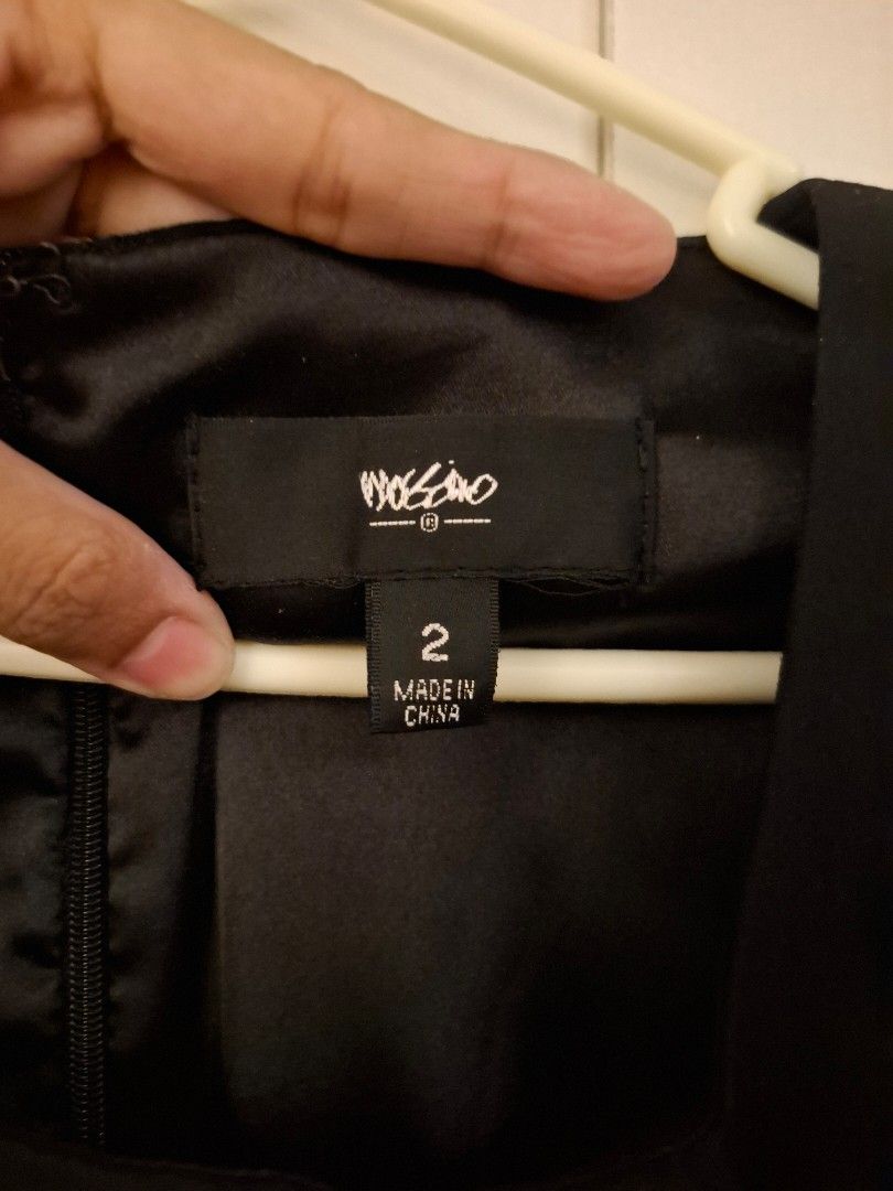 Mossimo Black Dress Size 2 (Category: Dresses) located in Tanza. Submitted by jajangmyeonnn (Listing ID 1468594406, Image 2). Description: - Brand: Mossimo - Color: Solid black - Size: 2 - Style: Sleeveless with an asymmetrical neckline fold and back zipper - Condition: Clean overall look with minimal wear on fabric - Origin: Made in China.