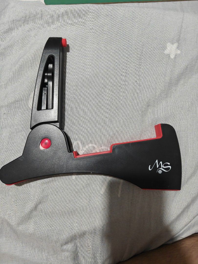 MS Portable Folding Guitar Stand (Category: Musical Instruments) located in Caloocan City. Submitted by mackenzie001 (Listing ID 1468667829, Image 2). Description: - Portable folding guitar stand in stylish black and red - Features the MS brand logo stamped on the side - Folds completely flat for hassle-free storage and transport - Equipped with rubber padding to protect your instrument from scratches - Solid and reliable build suitable for both 