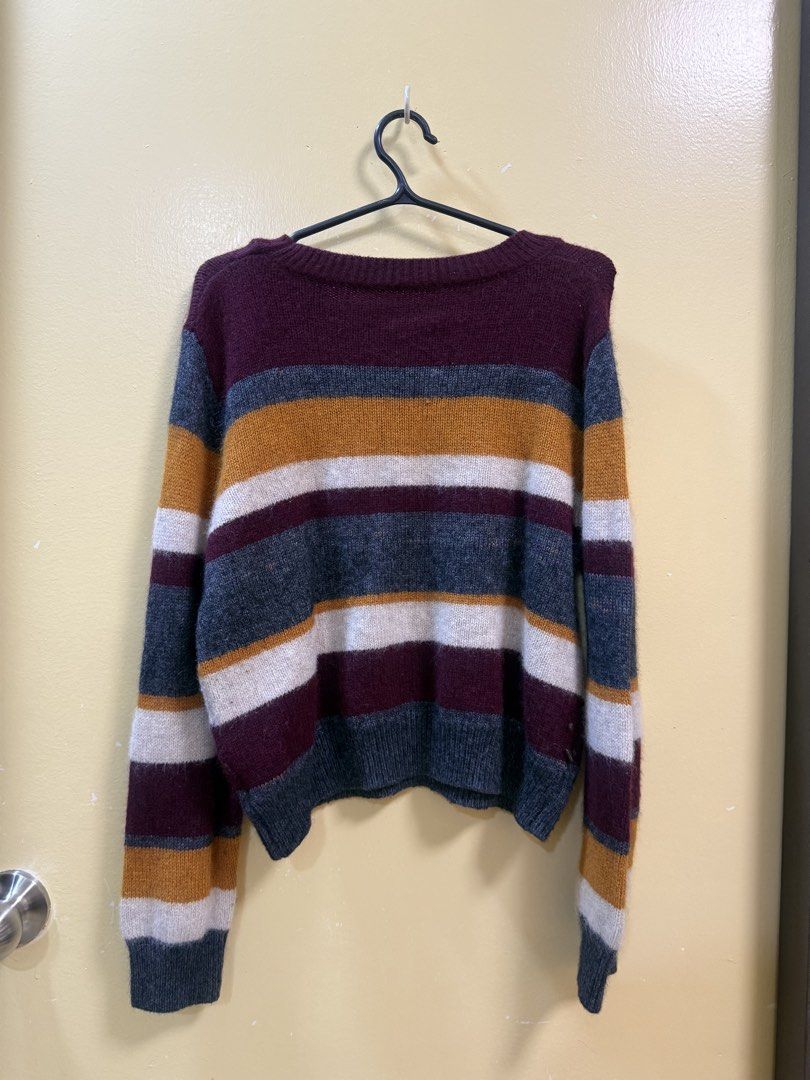 Multicolor Striped Knit Long Sleeve Sweater (Category: Longsleeves) located in Makati City. Submitted by shoprory (Listing ID 1468596322, Image 2). Description: - Design: Horizontal stripes in maroon, mustard yellow, white, and charcoal grey - Fit: Relaxed, comfortable fit with long sleeves - Details: Classic crew neckline with ribbed collar, cuffs, and hem - Material: Warm knit fabric, ideal for chilly weather - Condition: Excellent, ready to we