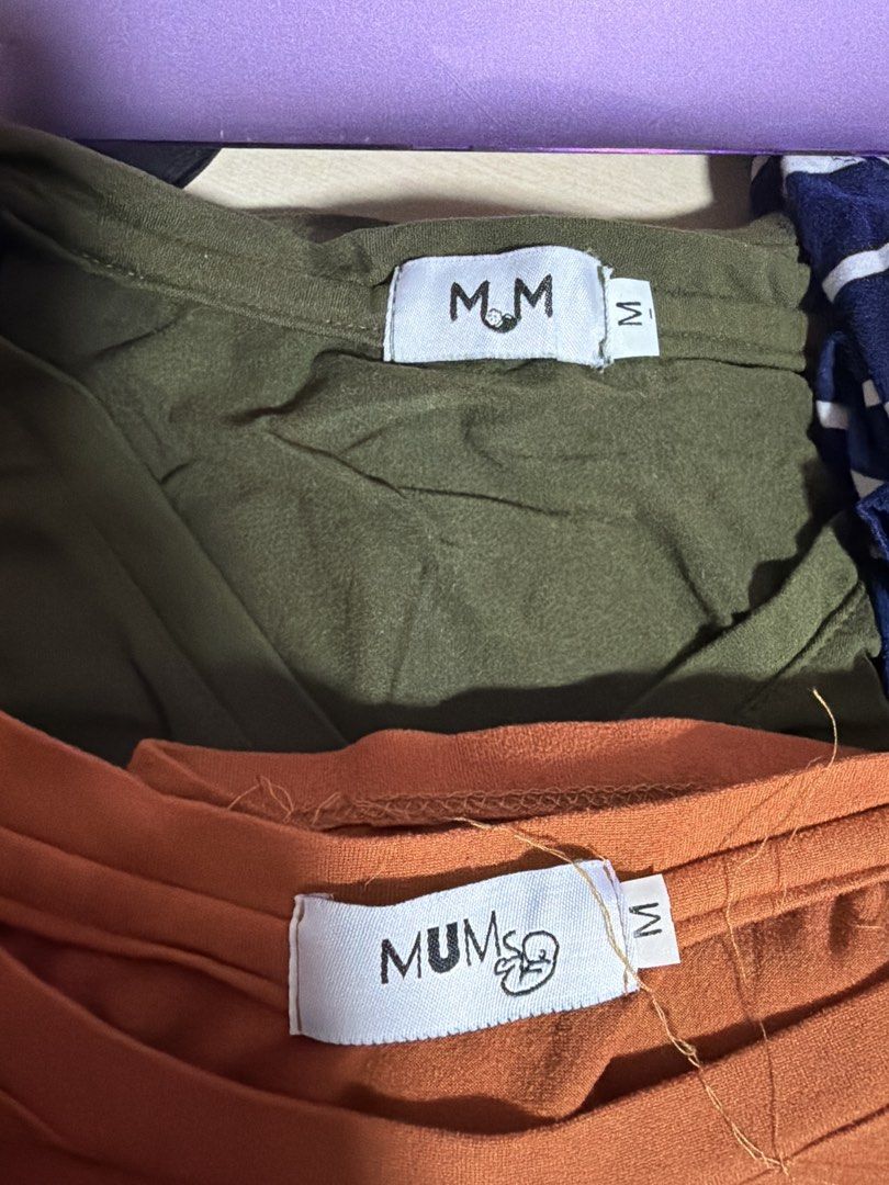 MUM & ME Maternity T-Shirt Bundle Size M (Category: Shirts) located in Manila. Submitted by hflores_23 (Listing ID 1468547338, Image 2). Description: - Brand: MUM - Size: Medium (M) - Quantity: Bundle of 4 tops - Colors: Olive green, terracotta orange, navy blue with white stripes, dusty pink - Features: Double-layered front design for easy nursing access and growing bump - Fabric: Soft cotton stretch for maximum comfort - Condition: Minimal wear