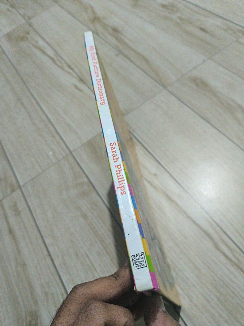 My First Picture Dictionary by Sarah Phillips (Category: Children's Books) located in Manila. Submitted by chayieinkie (Listing ID 1468707050, Image 3). Description: - Title: My First Picture Dictionary by Sarah Phillips - Publisher: Castle Street Press - Format: Hardcover with colorful illustrations - Features: Handy alphabet tabs on the side for easy navigation - Age Range: Recommended for kids 5 years and up - Benefits: Perfect for learning ba