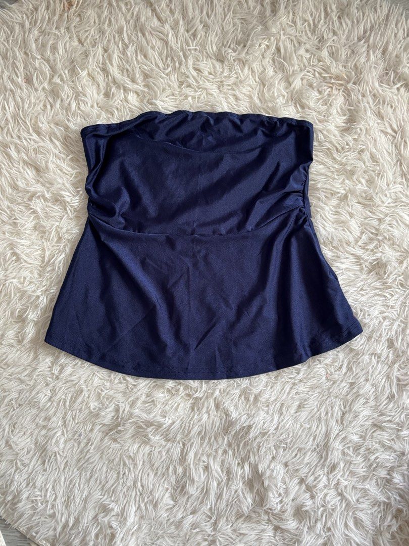Navy Blue Bandeau Swimsuit Top (Category: Bikinis & Swimsuits) located in Quezon City. Submitted by lovedbysloane (Listing ID 1468597518, Image 1). Description: - Color: Dark Blue - Style: Strapless bandeau with a flared bottom drape - Details: Flattering ruched sides - Material: Smooth and stretchy fabric - Ideal for: Beach days, pool parties, and vacations.