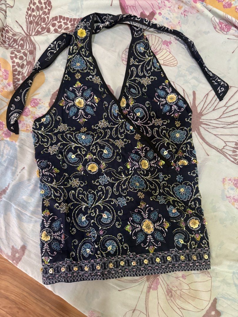 Navy blue floral beaded sequin halter top (Category: Sleeveless) located in Cebu City. Submitted by hotchkisscebu (Listing ID 1468703536, Image 3). Description: - Color: Dark blue with intricate floral prints and sparkly sequins - Fit: Halter neck tie with heavy smocked back for extra stretch and comfort - Style: Chic, trendy, and eye-catching - Occasion: Ideal for casual nights out, beach trips, or summer parties - Condition: Brand new / Excelle