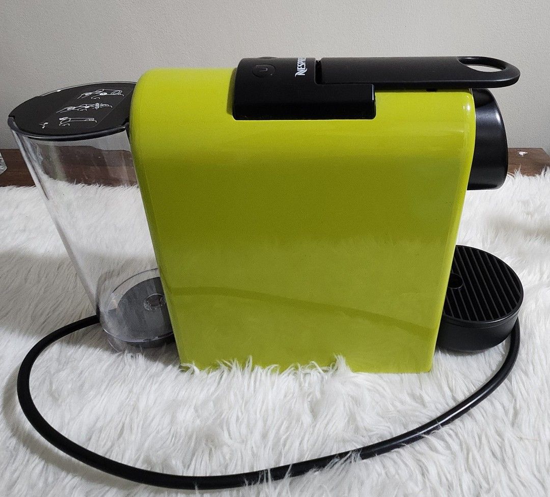 Nespresso Essenza Mini Coffee Maker (Category: Coffee Machines & Makers) located in Taytay. Submitted by luxebagcray (Listing ID 1468577736, Image 2). Description: - Model: Nespresso Essenza Mini Coffee Maker D30 - Color: Vibrant lime green - Design: Compact and space-saving for any countertop - Compatibility: Works with standard Nespresso capsules - Features: Easy-to-use top buttons for cup size selection - Inclusions: Clear water tank, removabl