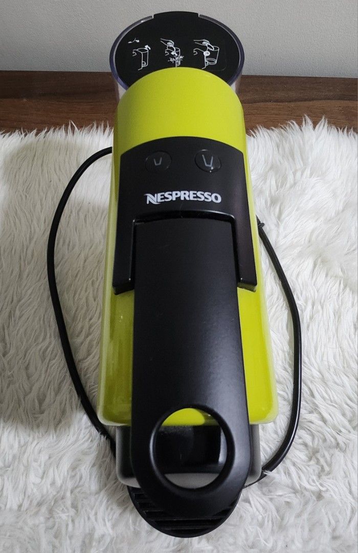 Nespresso Essenza Mini Coffee Maker (Category: Coffee Machines & Makers) located in Taytay. Submitted by luxebagcray (Listing ID 1468577736, Image 1). Description: - Model: Nespresso Essenza Mini Coffee Maker D30 - Color: Vibrant lime green - Design: Compact and space-saving for any countertop - Compatibility: Works with standard Nespresso capsules - Features: Easy-to-use top buttons for cup size selection - Inclusions: Clear water tank, removabl