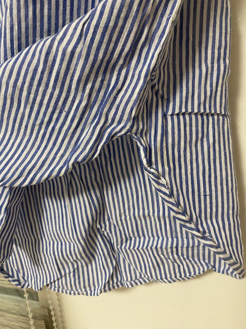 New Direction Blue and White Striped Blouse Size M (Category: Blouses) located in Cavite. Submitted by yc.shoppemnl (Listing ID 1468523778, Image 2). Description: - Brand: New Direction - Size: Medium (tag on collar) - Color/Pattern: Blue and white stripes - Material: Lightweight and breezy fabric (Made in India) - Design: Short sleeves with folded cuffs, V-neckline with collar, and a rounded, asymmetrical high-low hem - Condition: Clean, excelle