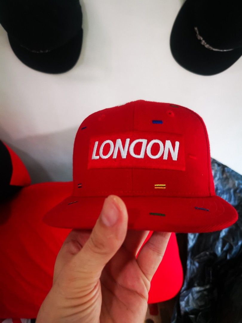New Era 9FIFTY London Red Snapback Cap (Category: Caps & Hats) located in Pasay City. Submitted by wizemindz138970 (Listing ID 1468590715, Image 2). Description: - Brand: New Era 9FIFTY - Style: Snapback cap (Size: Small to Medium) - Color/Pattern: Red with multicolored dash patterns - Design: Embroidered London box logo on the front - Material: 100% wool - Closure: Adjustable snapback with New Era branding - Condition: Brand new with clean inter