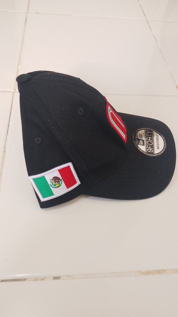 New Era 9FORTY Mexico Baseball Cap Black (Category: Caps & Hats) located in Caloocan City. Submitted by tamonchi (Listing ID 1468649949, Image 2). Description: - Authentic New Era 9FORTY adjustable cap in black - Embroidered Mexico 'M' logo on the front with a side Mexican flag patch - Classic curved brim with original sticker still attached - Adjustable snapback closure for a customizable fit - Clean interior lining with official branded taping 
