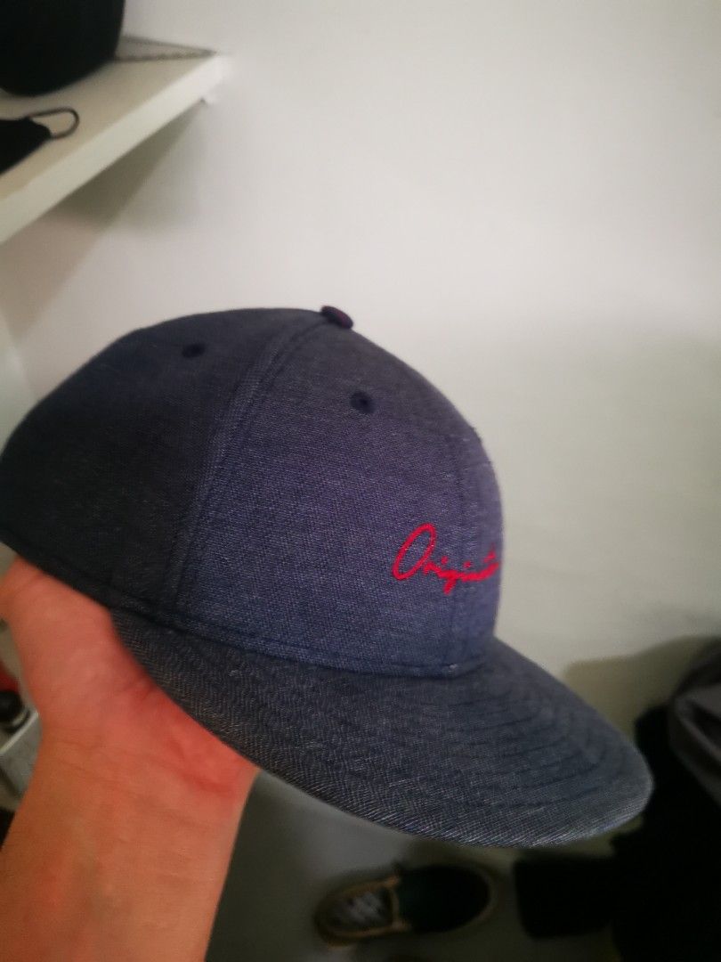 New Era Originator 9FIFTY Low Profile Cap (Category: Caps & Hats) located in Pasay City. Submitted by wizemindz138970 (Listing ID 1468591362, Image 1). Description: - Brand: New Era 9FIFTY Low Profile Hat - Material/Texture: Dark denim - Embroidery: Red 'Originator' script on front, classic red New Era flag on left side - Interior: Navy and red striped lining with 9FIFTY taped seams - Fit: Adjustable strap closure at the back (Size: Medium-Large)