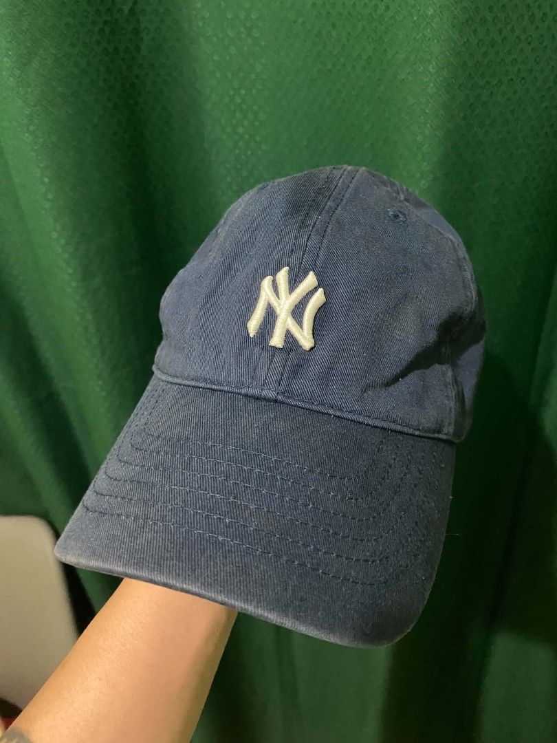 New York Yankees MLB Navy Blue Dad Hat Cap (Category: Caps & Hats) located in Quezon City. Submitted by elihur.tuazon (Listing ID 1468685934, Image 1). Description: - Authentic New York Yankees dad hat in classic navy blue - Features white embroidered NY logo on the front and MLB batterman logo at the back - Adjustable strap closure with an MLB-branded metal slider buckle - Designed with branded inner taping and internal tags - Comfortable, casua