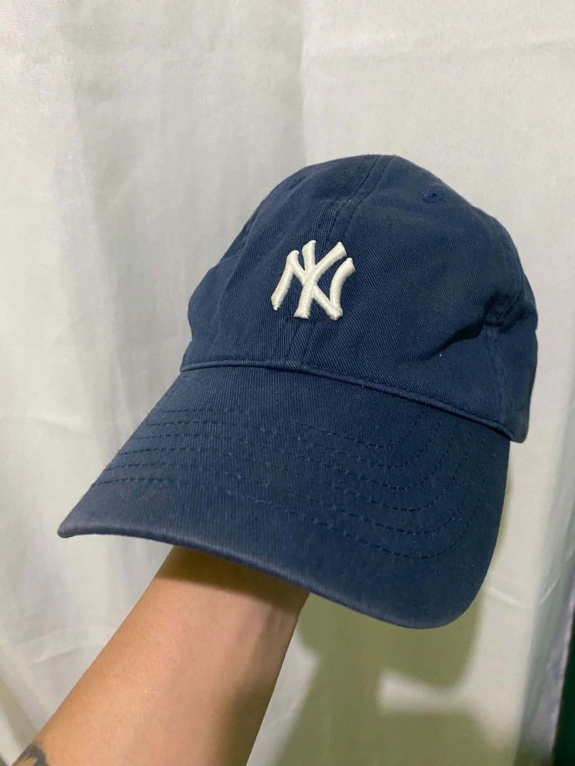 New York Yankees MLB Navy Blue Dad Hat Cap (Category: Caps & Hats) located in Quezon City. Submitted by elihur.tuazon (Listing ID 1468685934, Image 2). Description: - Authentic New York Yankees dad hat in classic navy blue - Features white embroidered NY logo on the front and MLB batterman logo at the back - Adjustable strap closure with an MLB-branded metal slider buckle - Designed with branded inner taping and internal tags - Comfortable, casua