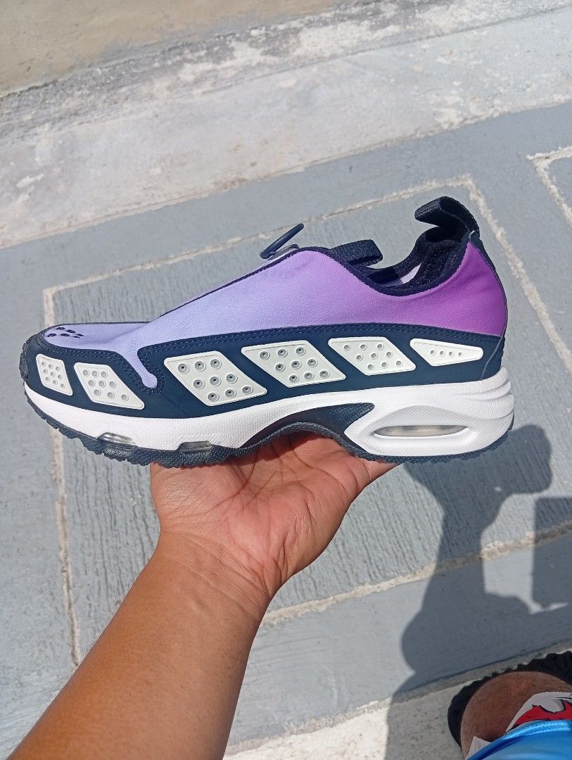 Nike Air Purple Sneakers (Category: Sneakers) located in Quezon City. Submitted by asu06 (Listing ID 1468525705, Image 2). Description: Nike Air Max SNDR (Air Sunder Max) Hyper Violet - Brand/Model: Nike Sneakers - Colorway: Purple and White - Design: Zippered lace cover with perforated side and toe panels - Sole: Chunky white sole with visible Air cushioning units - Convenience: Pull tabs at the heel and tongue for easy slip-on wear - Condition: