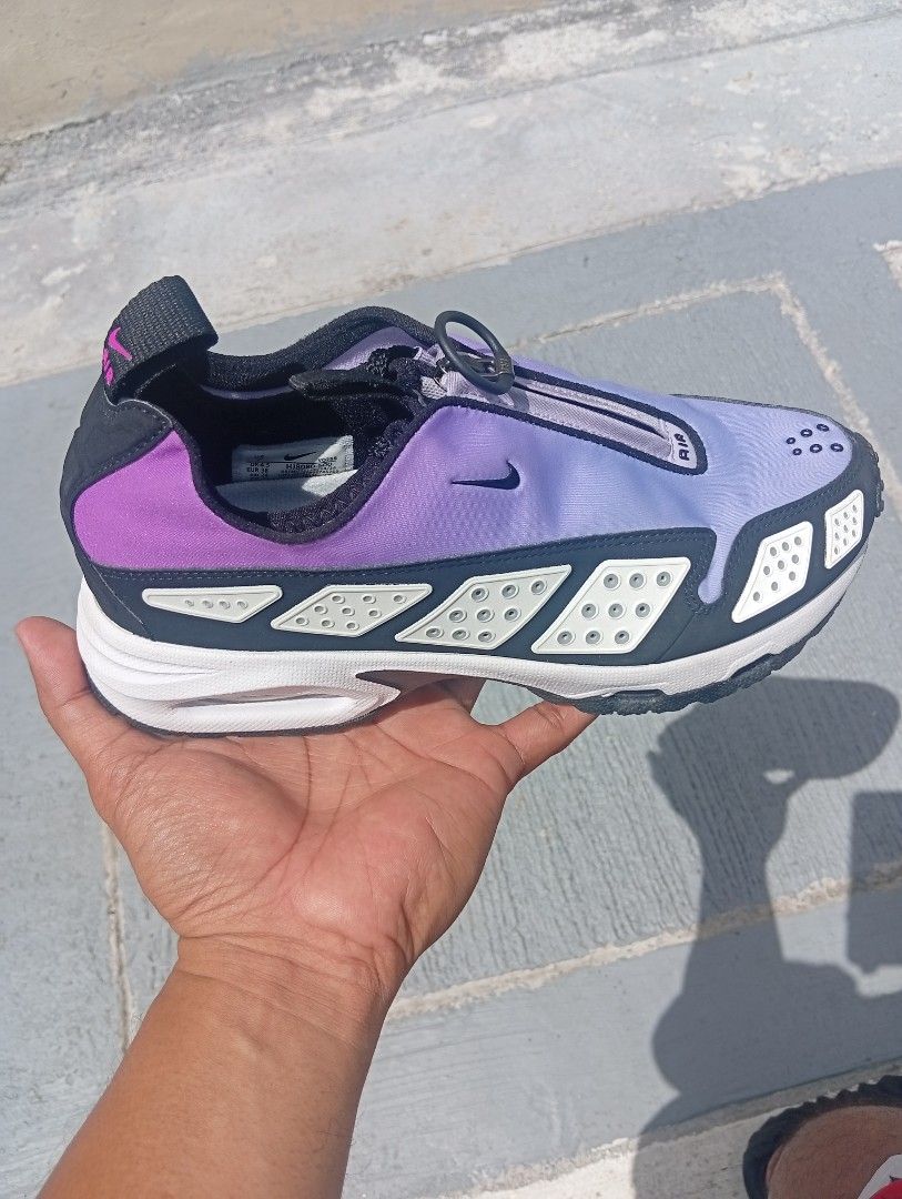 Nike Air Purple Sneakers (Category: Sneakers) located in Quezon City. Submitted by asu06 (Listing ID 1468525705, Image 3). Description: Nike Air Max SNDR (Air Sunder Max) Hyper Violet - Brand/Model: Nike Sneakers - Colorway: Purple and White - Design: Zippered lace cover with perforated side and toe panels - Sole: Chunky white sole with visible Air cushioning units - Convenience: Pull tabs at the heel and tongue for easy slip-on wear - Condition: