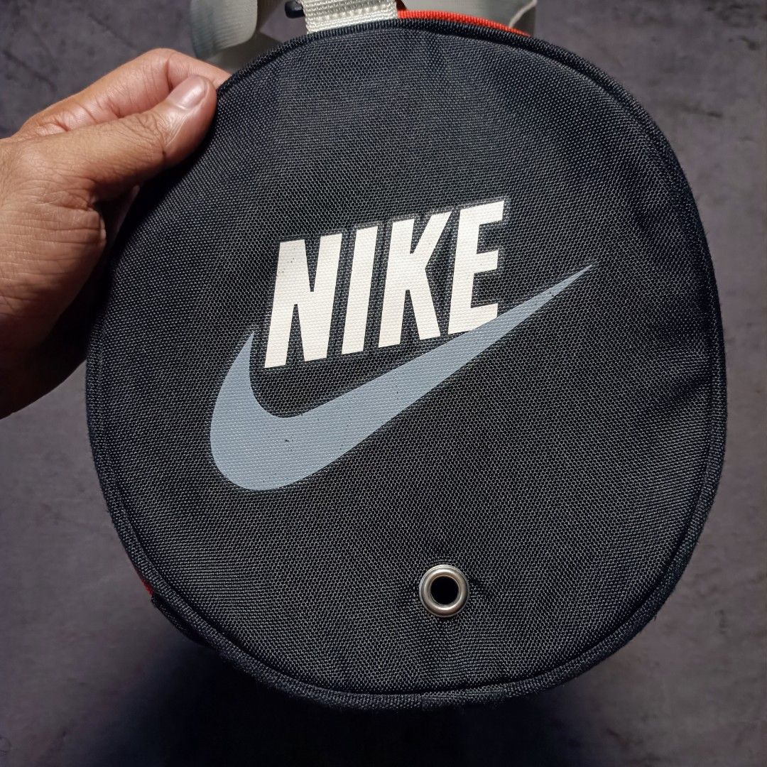 Nike Black and Red Mini Duffel Bag (Category: Sling Bags) located in Manila. Submitted by nye.seller (Listing ID 1468531821, Image 3). Description: - Brand: Nike - Color: Classic Black & Red - Style: Mini duffel bag (gym or travel) - Material: Durable polyester - Features: Adjustable shoulder strap, dual carry handles, and zip main compartment with clean interior - Design: Large Nike logo on the round side panel - Condition: Brand new / Excellent