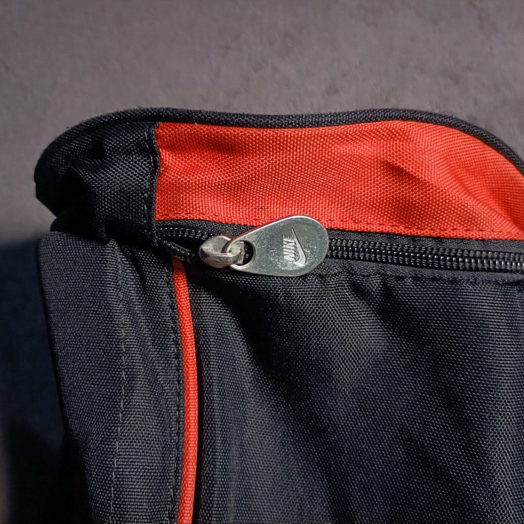 Nike Black and Red Mini Duffel Bag (Category: Sling Bags) located in Manila. Submitted by nye.seller (Listing ID 1468531821, Image 2). Description: - Brand: Nike - Color: Classic Black & Red - Style: Mini duffel bag (gym or travel) - Material: Durable polyester - Features: Adjustable shoulder strap, dual carry handles, and zip main compartment with clean interior - Design: Large Nike logo on the round side panel - Condition: Brand new / Excellent