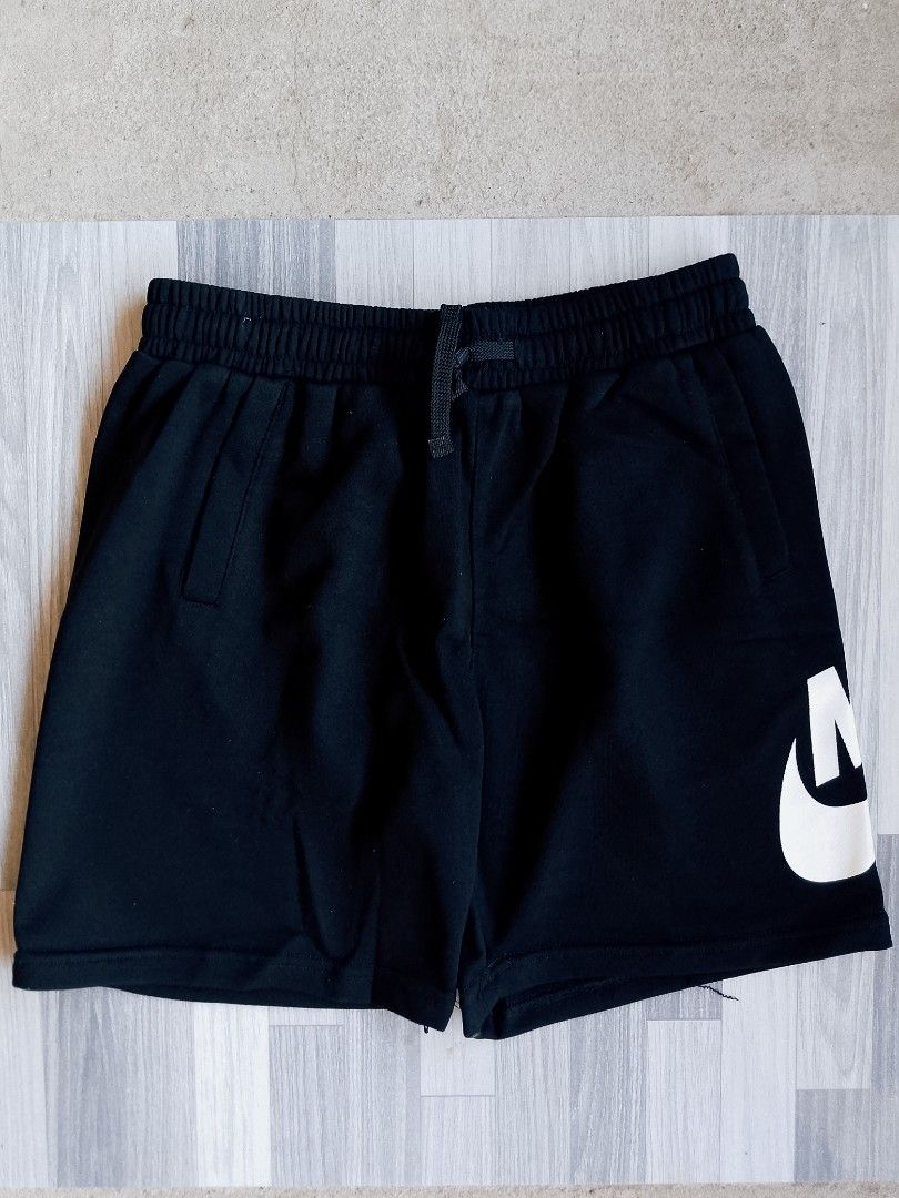 Nike Black Shorts with Large Logo (Category: Shorts) located in Batangas. Submitted by rafstaywitstaff_11 (Listing ID 1468585291, Image 2). Description: - Color: Classic Black - Material: Soft, breathable fabric for ultimate comfort - Design: Bold white Nike text logo on one side and swoosh logo on the other - Fit: Secure elastic waistband with adjustable drawstring - Features: Two convenient side pockets - Best For: Gym workouts, sports, or casu