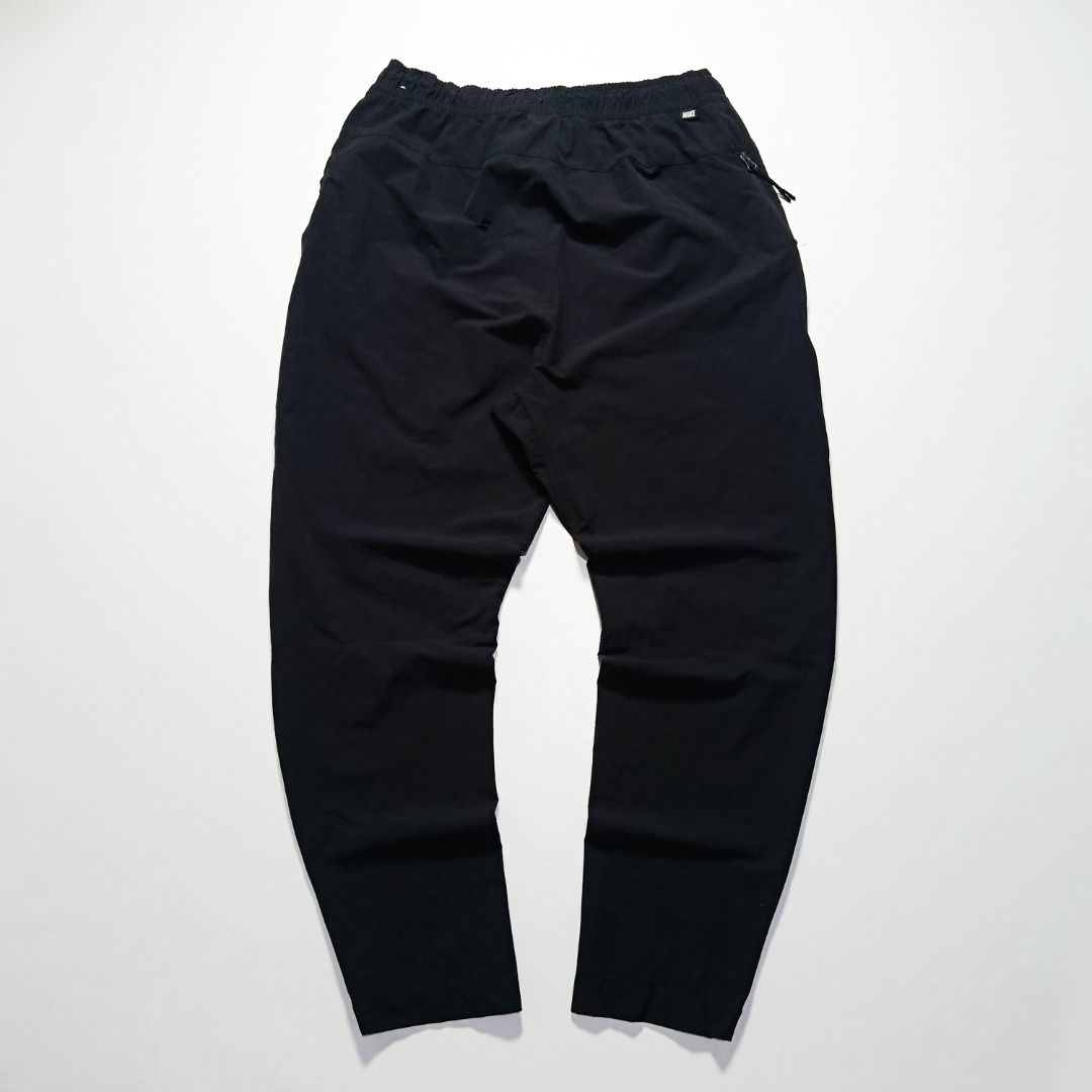 Nike Black Straight-Leg Woven Pants (Category: Joggers) located in Taytay. Submitted by hoodgrail.vtg (Listing ID 1468621225, Image 2). Description: • Excellent condition - Lightly used • Lightweight nylon-stretch fabric, subtle printed Swoosh logo and zippered side pocket • Size on tag: XL — best fits 28–32 • Measurements: 14.5 x 38.5 in • Leg opening: 5 in • Color rate: 9.5/10 • Issue: None.