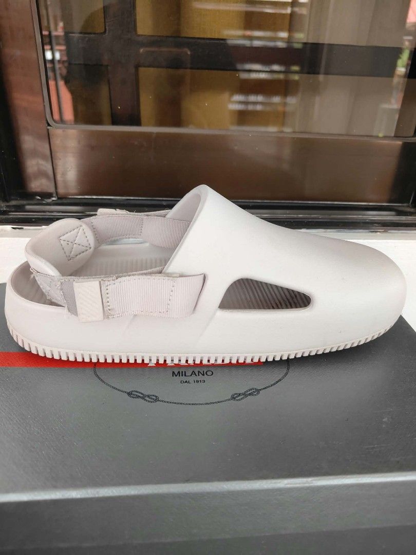 Nike Calm Slide Sandals Beige (Category: Slippers & Slides) located in Plaridel. Submitted by jkauthentics (Listing ID 1468536924, Image 1). Description: Used once❤️ - Brand: Nike Calm Slides - Color: Beige - Style: Slip-on with adjustable back strap and side cut-outs - Features: Embossed Nike swoosh, ribbed footbed, and textured sole for grip - Condition: Like new with slight scuffs on the soles from trial only.