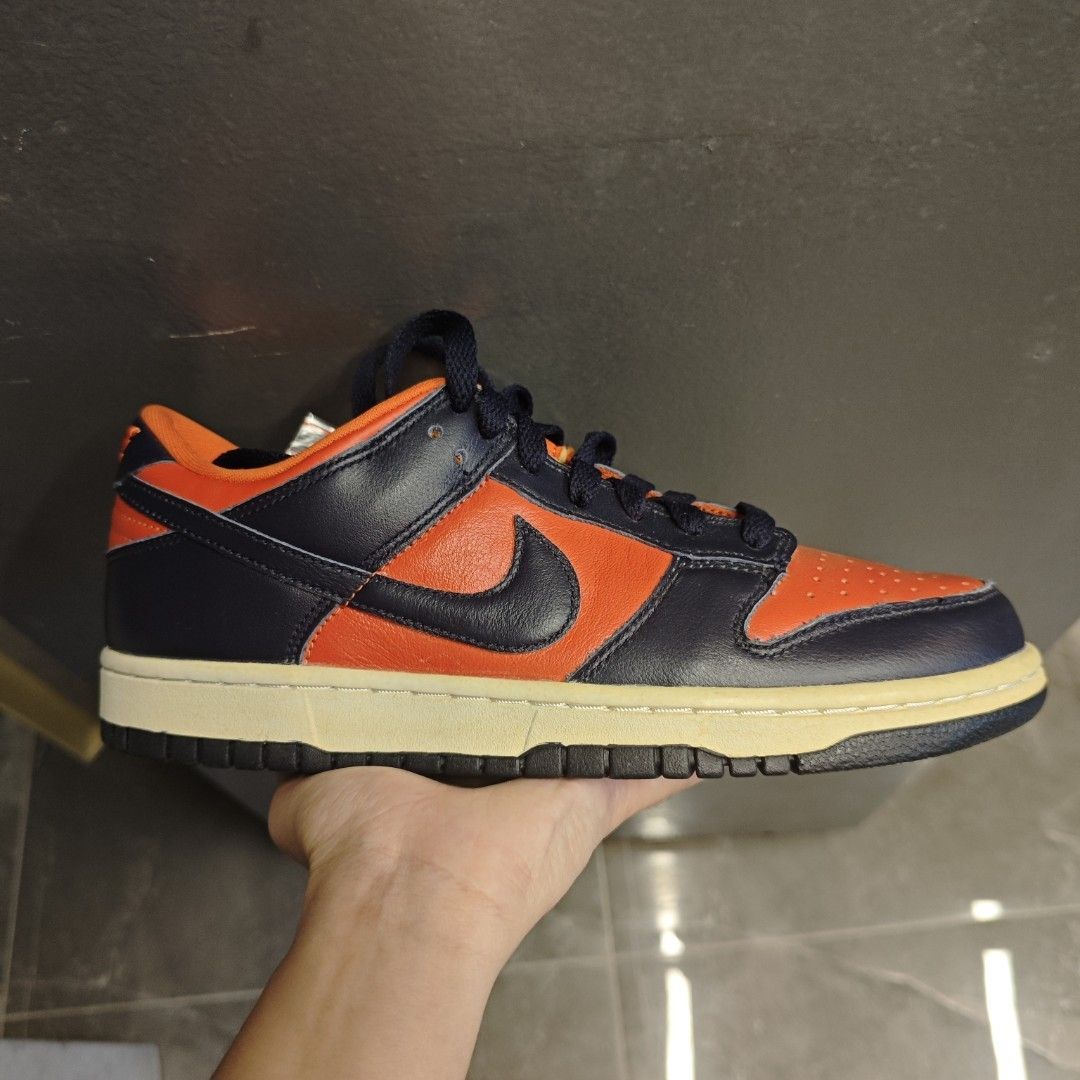 Nike Dunk Low Champ (Category: Sneakers) located in Iloilo. Submitted by teezeewhyyy (Listing ID 1468652299, Image 1). Description: - Brand: Nike - Model: Dunk Low - Colorway: Bright Orange and Dark Navy Blue - Details: Perforated toe box, contrast stitching, matching dark laces - Midsole: Cream-colored for a stylish vintage look - Condition: Brand new / pristine - Perfect for: Everyday wear and sneaker collectors.