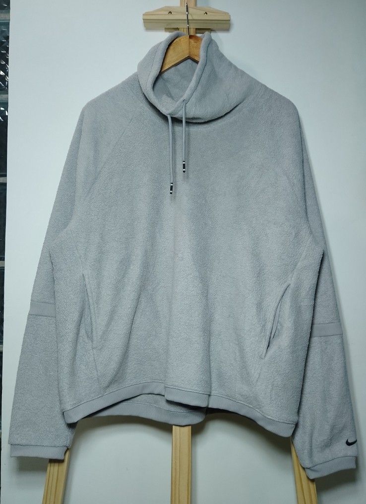 Nike Gray Fleece High Neck Sweatshirt (Category: Coats, Jackets and Outerwear) located in Manila. Submitted by patrickjos06722 (Listing ID 1468673220, Image 1). Description: - Brand: Nike - Color: Gray - Material: Warm fleece - Neckline: High cowl neck with adjustable drawstrings - Features: Two front pockets, raglan sleeves with ribbed panels, subtle embroidered Swoosh on left cuff - Measurements (laid flat): Chest width ~23", Length ~24.5", Sle