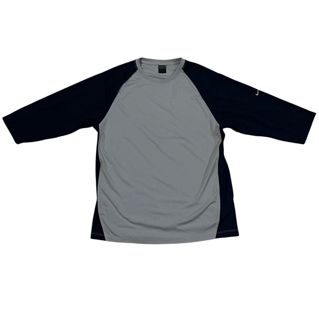 Nike Gray Navy Raglan Baseball Tee (Category: Activewear) located in Cagayan de Oro. Submitted by lootfindzzzz (Listing ID 1468618326, Image 1). Description: - Brand: Nike - Style: Baseball tee with 3/4 raglan sleeves - Color: Gray body with navy blue sleeves and side panels - Logo: Small white swoosh near left shoulder - Material: Lightweight athletic fabric - Condition: Clean, excellent overall - Ideal for: Workouts or casual everyday wear.