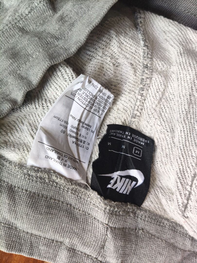 Nike Grey Sweat Shorts Size M (Category: Shorts) located in Caloocan City. Submitted by balizaclar77072 (Listing ID 1468650176, Image 2). Description: - Brand: Nike - Style: Sweat shorts with raw edge hem - Color: Grey with large white Nike logo on left leg and white drawstring - Size: Medium (M) - Material: Comfortable cotton and polyester blend - Origin: Made in Thailand - Condition/Use: Great for casual wear, lounging, or workouts.