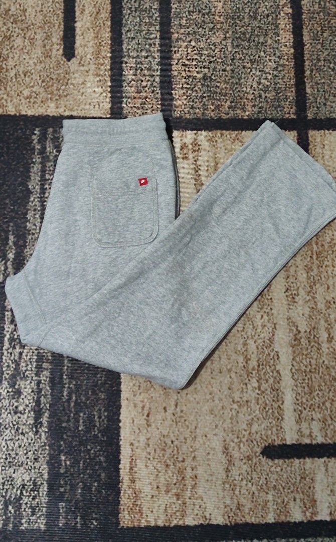 Nike Grey Sweatpants Joggers Size L (Category: Joggers) located in Manila. Submitted by ianmontede19006 (Listing ID 1468509875, Image 2). Description: - Brand: Nike - Size: L - Color: Grey - Material: Soft and comfortable cotton blend - Features: Elastic waistband with black adjustable drawstrings - Details: Small white embroidered Nike swoosh on the left thigh and a red Nike tag on the back pocket - Condition: Clean inside care tag - Origin: Mad