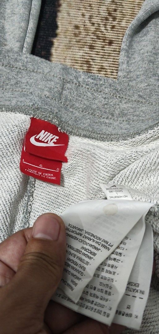 Nike Grey Sweatpants Joggers Size L (Category: Joggers) located in Manila. Submitted by ianmontede19006 (Listing ID 1468509875, Image 3). Description: - Brand: Nike - Size: L - Color: Grey - Material: Soft and comfortable cotton blend - Features: Elastic waistband with black adjustable drawstrings - Details: Small white embroidered Nike swoosh on the left thigh and a red Nike tag on the back pocket - Condition: Clean inside care tag - Origin: Mad