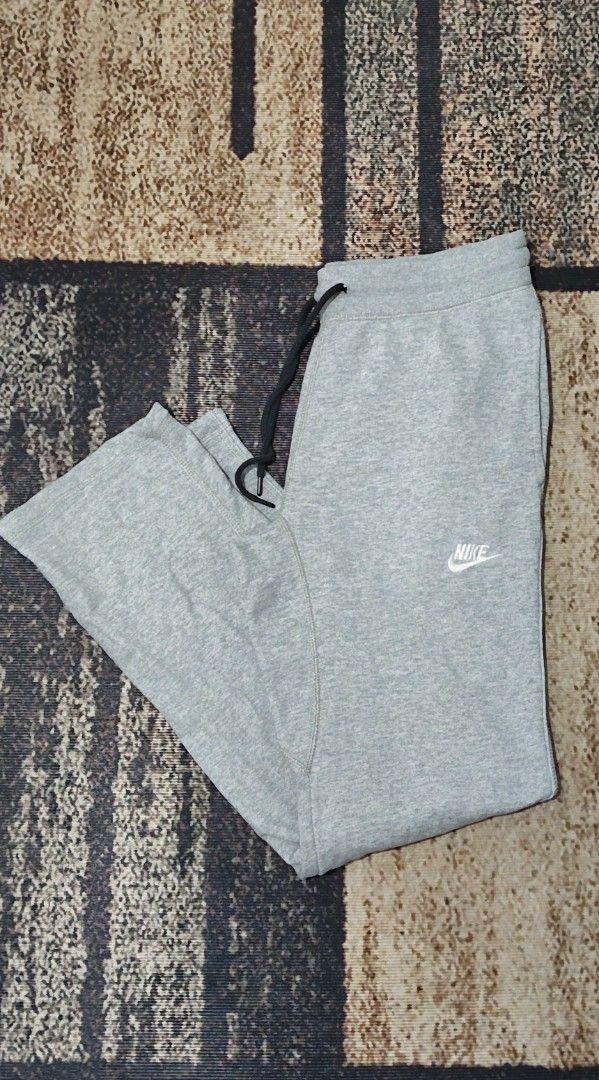 Nike Grey Sweatpants Joggers Size L (Category: Joggers) located in Manila. Submitted by ianmontede19006 (Listing ID 1468509875, Image 1). Description: - Brand: Nike - Size: L - Color: Grey - Material: Soft and comfortable cotton blend - Features: Elastic waistband with black adjustable drawstrings - Details: Small white embroidered Nike swoosh on the left thigh and a red Nike tag on the back pocket - Condition: Clean inside care tag - Origin: Mad