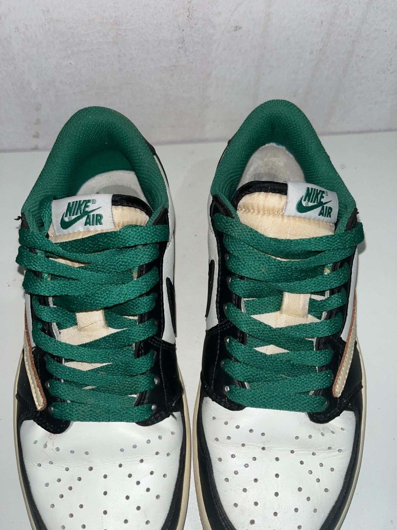 Nike Jordan 1 Low Travis Scott Green (Category: Sneakers) located in Manila. Submitted by wildwolf.e866c3 (Listing ID 1468620795, Image 2). Description: - Brand/Model: Nike Air Jordan 1 Low - Size: EUR 38.5 - Colorway: White leather, black overlays, green accents, cream reverse swoosh, green laces - Special Details: Cactus Jack embroidery on one heel, Jordan wings and Fragment logo on the other - Condition: Shows wear on midsoles and soles with c