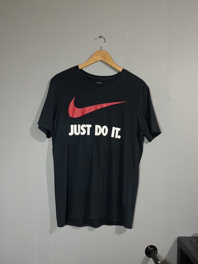 Nike Just Do It Black T-Shirt (Category: Tshirts & Polo Shirts ) located in Butuan. Submitted by thriftheadsofficial (Listing ID 1468505127, Image 1). Description: - Brand: Nike - Color: Black with red swoosh and white 'Just Do It' text - Size: L (Standard fit) - Material: 100% Cotton - Condition: Excellent / Pre-loved - Style: Crew neck, short sleeves, casual everyday wear - Origin: Made in China - Mode of Payment: GCash or BPI - Shipping: Via J