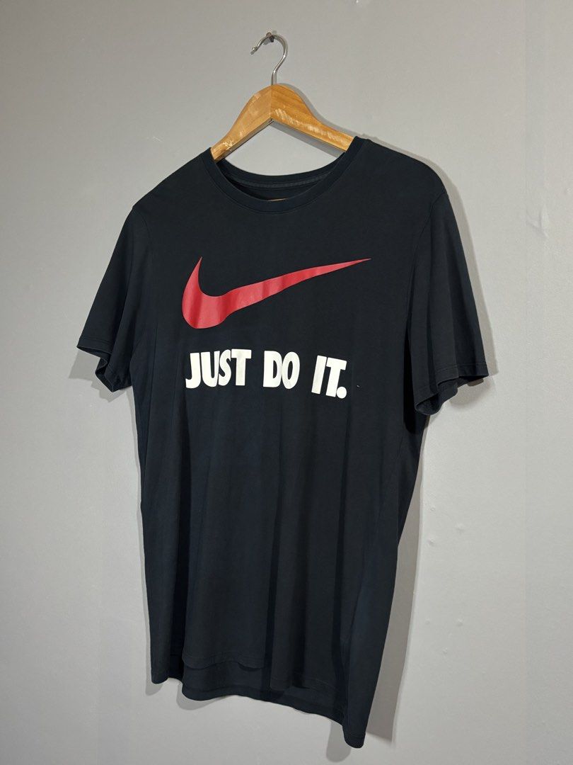 Nike Just Do It Black T-Shirt (Category: Tshirts & Polo Shirts ) located in Butuan. Submitted by thriftheadsofficial (Listing ID 1468505127, Image 2). Description: - Brand: Nike - Color: Black with red swoosh and white 'Just Do It' text - Size: L (Standard fit) - Material: 100% Cotton - Condition: Excellent / Pre-loved - Style: Crew neck, short sleeves, casual everyday wear - Origin: Made in China - Mode of Payment: GCash or BPI - Shipping: Via J
