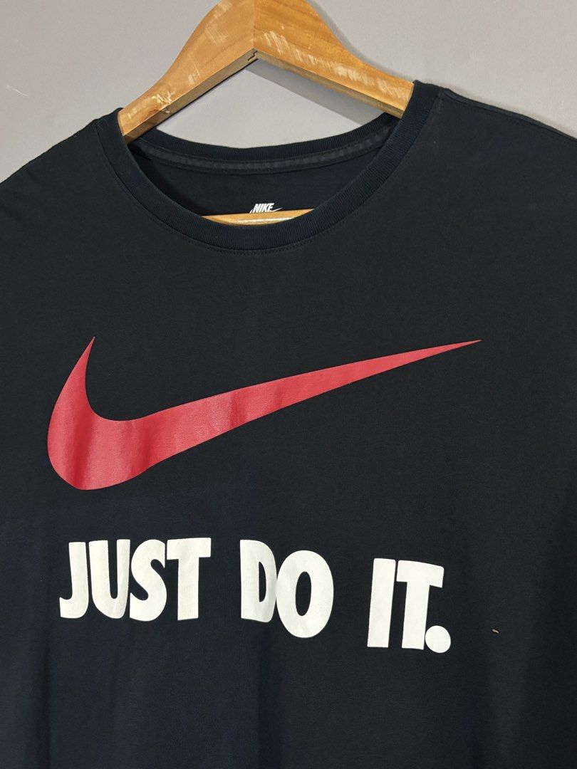 Nike Just Do It Black T-Shirt (Category: Tshirts & Polo Shirts ) located in Butuan. Submitted by thriftheadsofficial (Listing ID 1468505127, Image 3). Description: - Brand: Nike - Color: Black with red swoosh and white 'Just Do It' text - Size: L (Standard fit) - Material: 100% Cotton - Condition: Excellent / Pre-loved - Style: Crew neck, short sleeves, casual everyday wear - Origin: Made in China - Mode of Payment: GCash or BPI - Shipping: Via J