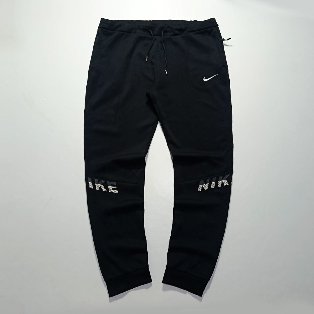 Nike Knee Graphic Black Jogger Pants (Category: Joggers) located in Taytay. Submitted by hoodgrail.vtg (Listing ID 1468621528, Image 1). Description: • Excellent condition - Like new • Contrasting Nike knee graphics, embroidered Swoosh logo, adjustable drawstring waist and tapered cuffs • Size on tag: 4XL — best fits 34–38 • Measurements: 18.5 x 41.5 in • Leg opening: 5.5 in (elastic) • Color rate: 9.5/10 • Issue: None.